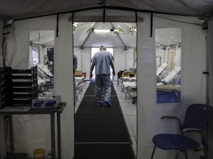 caption: A temporary tent was set up at UMass Memorial Hospital in Worcester, Mass., to prepare for an uptick in COVID-19 cases this month.