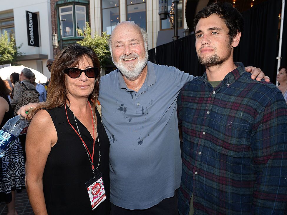 caption: FILE — Actor/Producer/Director Rob Reiner (center) and wife Michele Singer (L) and son Nick Reiner (R) attend Teen Vogue's Back-to-School Saturday kick-off event at The Grove on August 9, 2013 in Los Angeles, California.