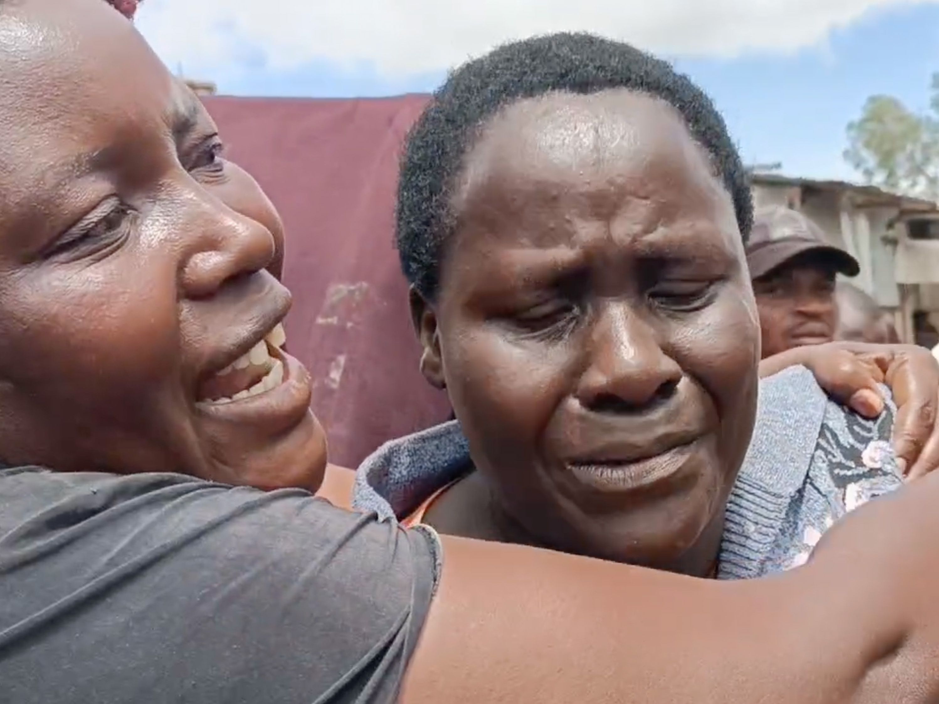 caption: Isabella Mogeni, 54, from the neighborhood of Mukuru kwa Reuben, looks on as bulldozers destroy homes in the slum area on May 3.