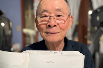 caption: Liem Ton holding his book, "My Little Story," on July 26, 2023.