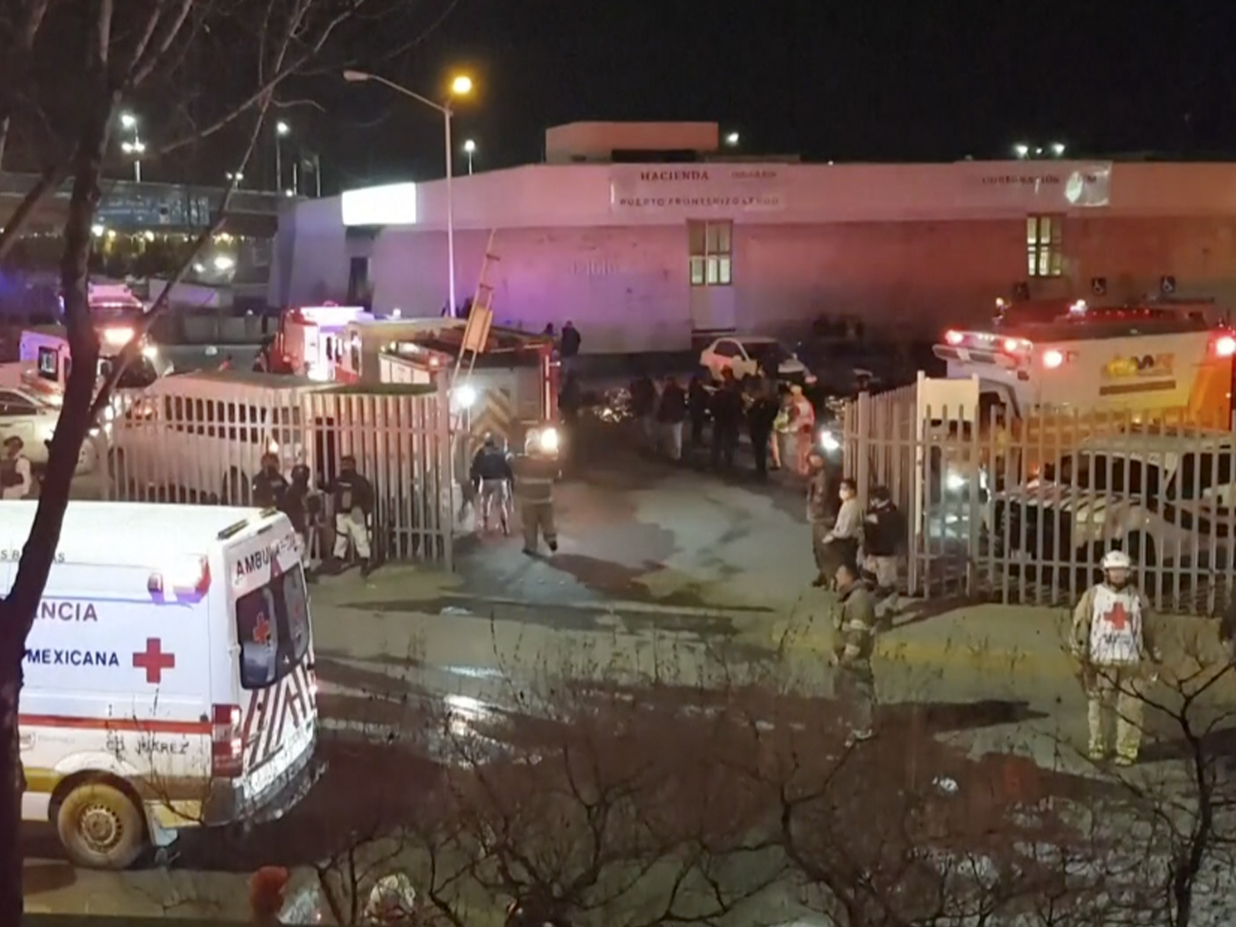 caption: An image taken from a video shows ambulances and rescue team staffers outside an immigration center in Ciudad Juarez, Mexico, on Tuesday.