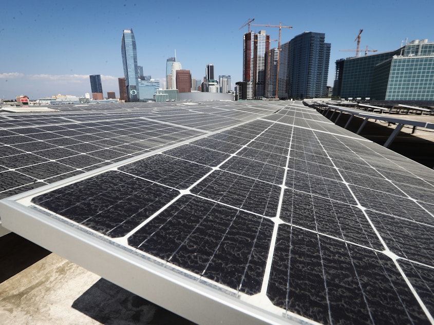 caption: Solar panels are mounted on the roof of the Los Angeles Convention Center on September 5. The state's governor has signed a landmark bill setting a goal of 100 percent clean energy for the state's electrical needs, by the year 2045.