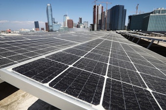 caption: Solar panels are mounted on the roof of the Los Angeles Convention Center on September 5. The state's governor has signed a landmark bill setting a goal of 100 percent clean energy for the state's electrical needs, by the year 2045.