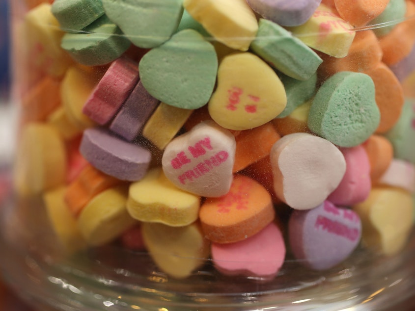 caption: Candy hearts are displayed on a shelf in Wilton Manors, Fla., in 2019. If you want to avoid processed, high-sugar candy, consider healthier alternatives for your loved one this year.