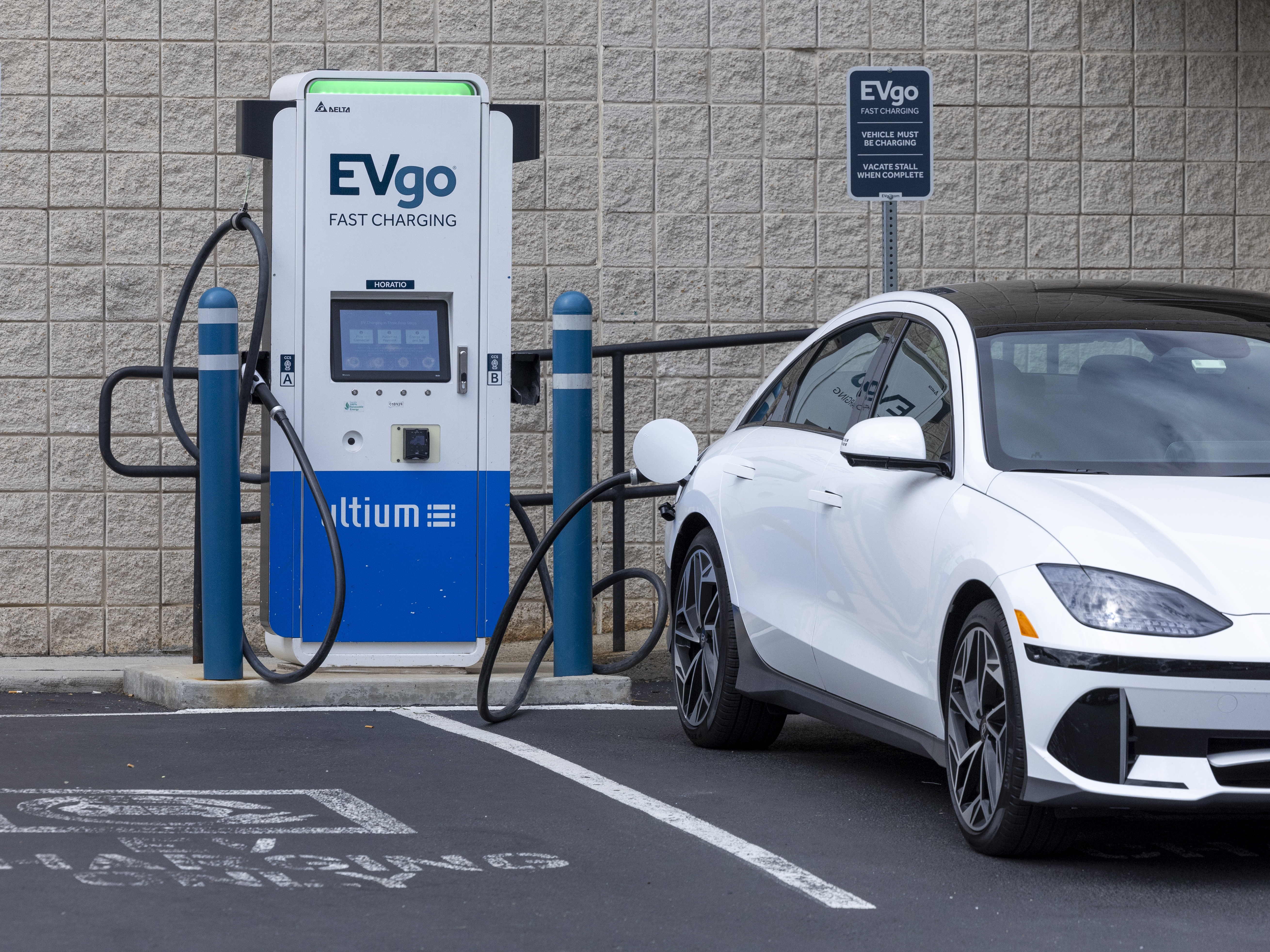 caption: An electric vehicle is seen charging in New Jersey on June 11, 2024. 