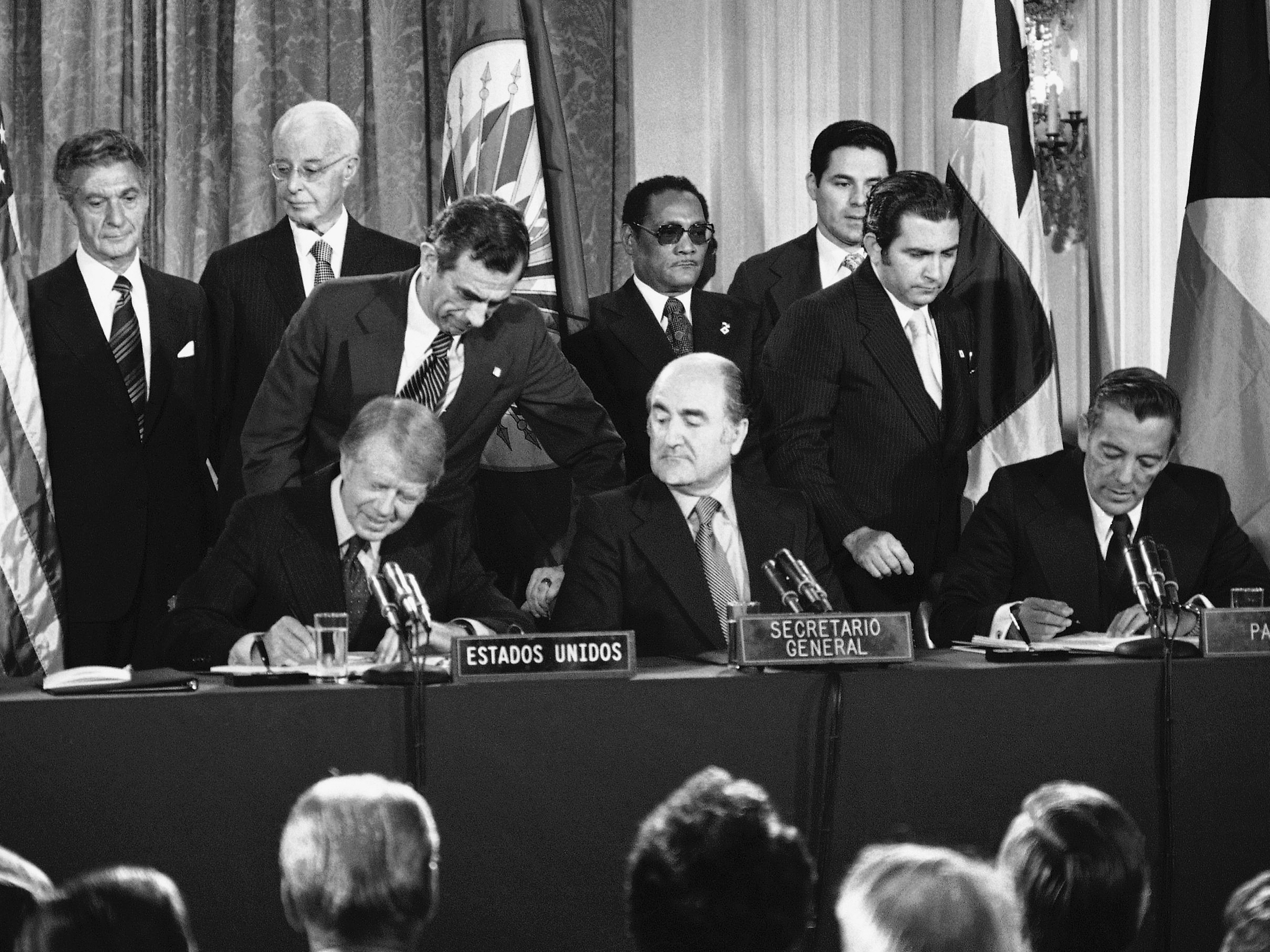 caption: Officials sign the Panama Canal treaties Sept. 7, 1977, at the Pan American Union in Washington, D.C. From left: President Jimmy Carter; Organization of American States Secretary-General Alejandro Orfila; and Panama's head of government Omar Torrijos.