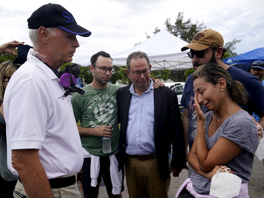 caption: Surfside, Fla., Mayor Charles Burkett (left) talks with Rachel Spiegel, whose mother is missing in the Champlain Towers South collapse.
