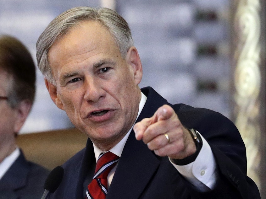 caption: Texas Gov. Greg Abbott is one of a few GOP governors who say migrants are the source of rising COVID-19 rates.