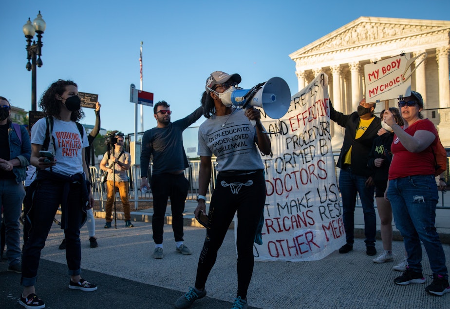 caption: Abortion rights demonstrators chant during a protest outside the Supreme Court on Tuesday.