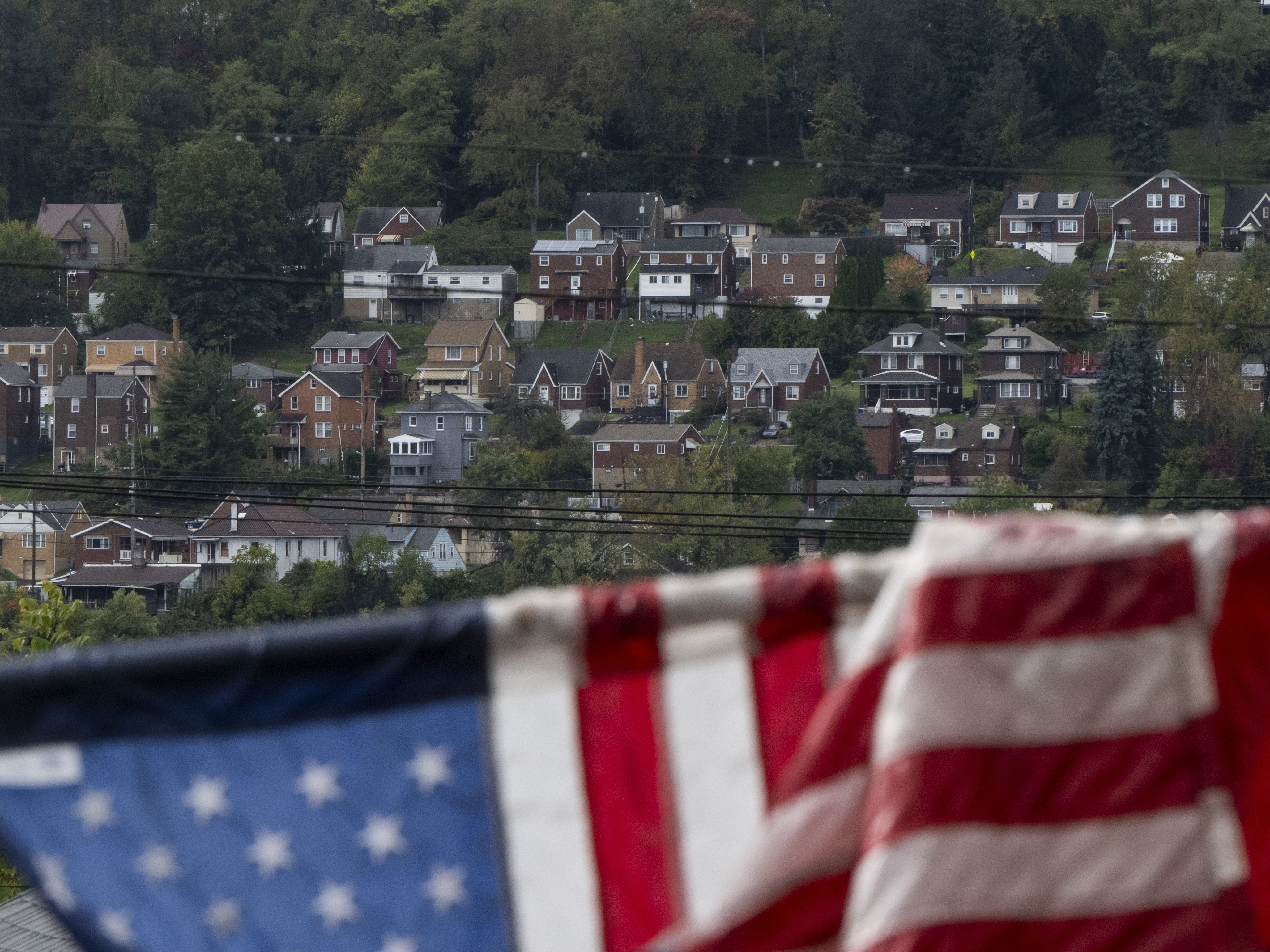 caption: Houses across the Monongahela River are seen from Braddock, Pa., on Oct. 16, 2024.