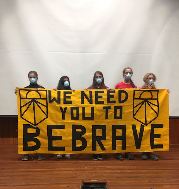 caption: Student protestors with the Sunrise Movement asked Senators Patty Murray and Maria Cantwell to sign onto the Green New Deal in a protest on December 16, 2019. 