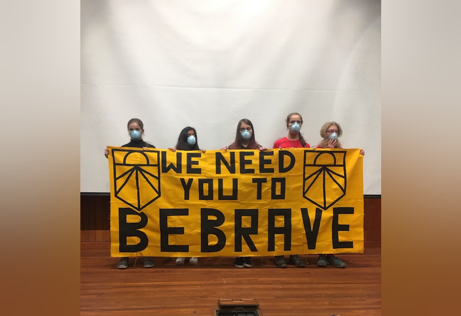 caption: Student protestors with the Sunrise Movement asked Senators Patty Murray and Maria Cantwell to sign onto the Green New Deal in a protest on December 16, 2019. 