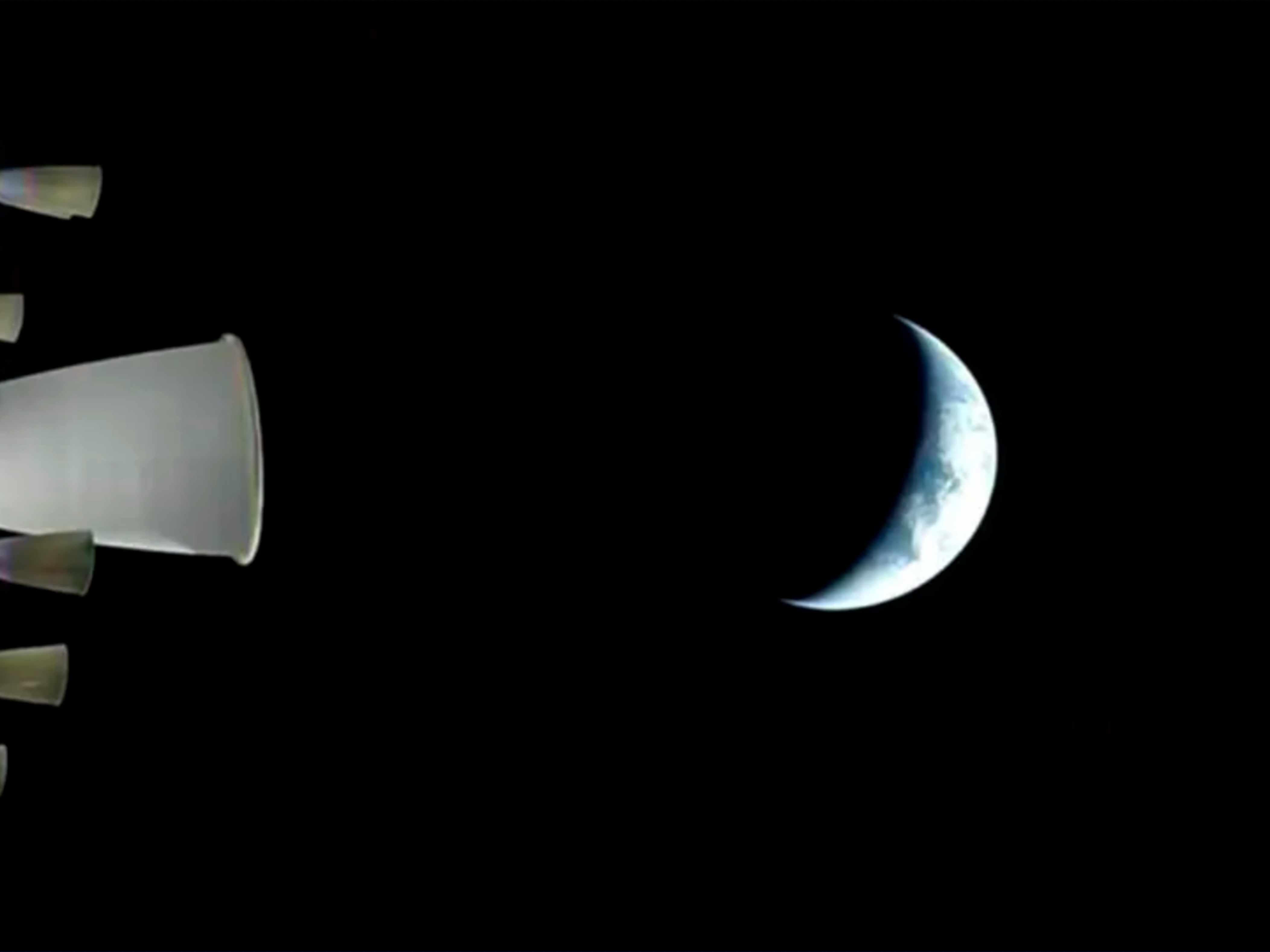 caption: In a photo provided by NASA, a view of Earth from NASA's Orion spacecraft during the Artemis II test flight Thursday. The crew completed a key burn, sending the capsule speeding to the moon for a lunar flyby.