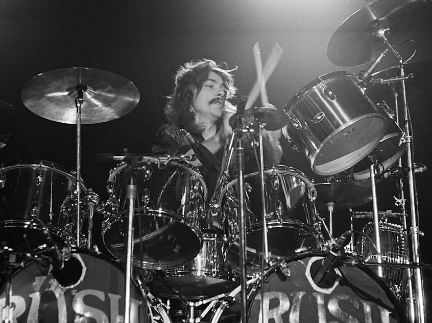 caption: Drummer Neil Peart, on stage with Rush in Springfield, Mass. in 1976.