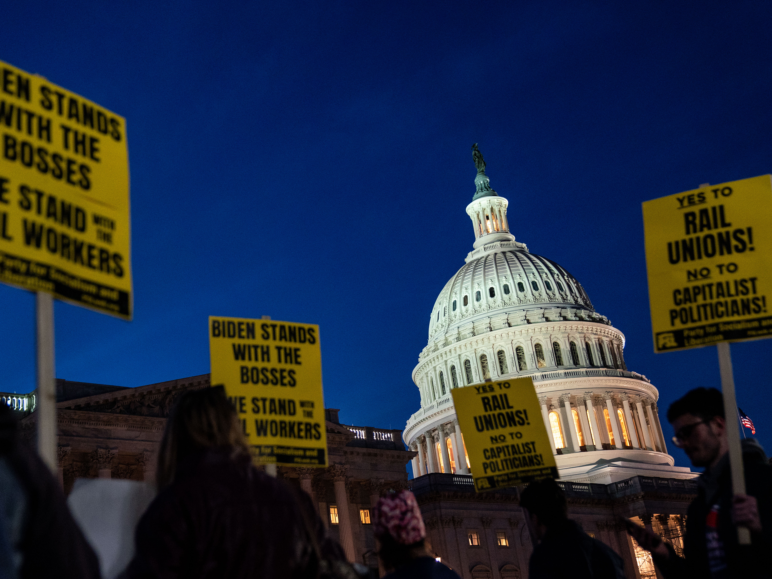 caption: Activists in support of unionized rail workers protest outside the House side of the Capitol on Tuesday.