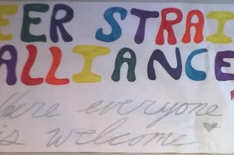 caption: A banner advertising the Queer-Straight Alliance at Interlake High School in Bellevue.