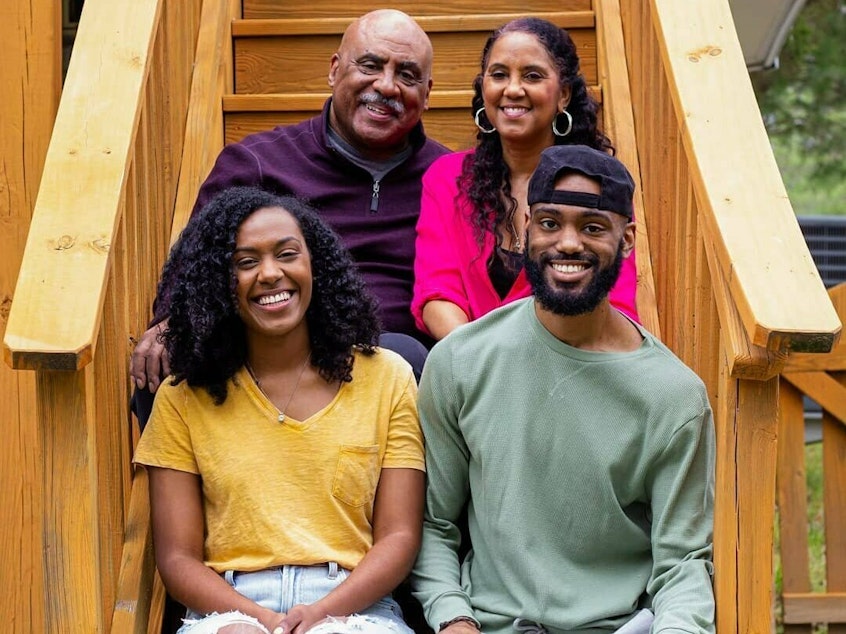 caption: Jeremy Nottingham (bottom right) sits for a family photo with his parents, Junius and Sharon, and sister Briana.