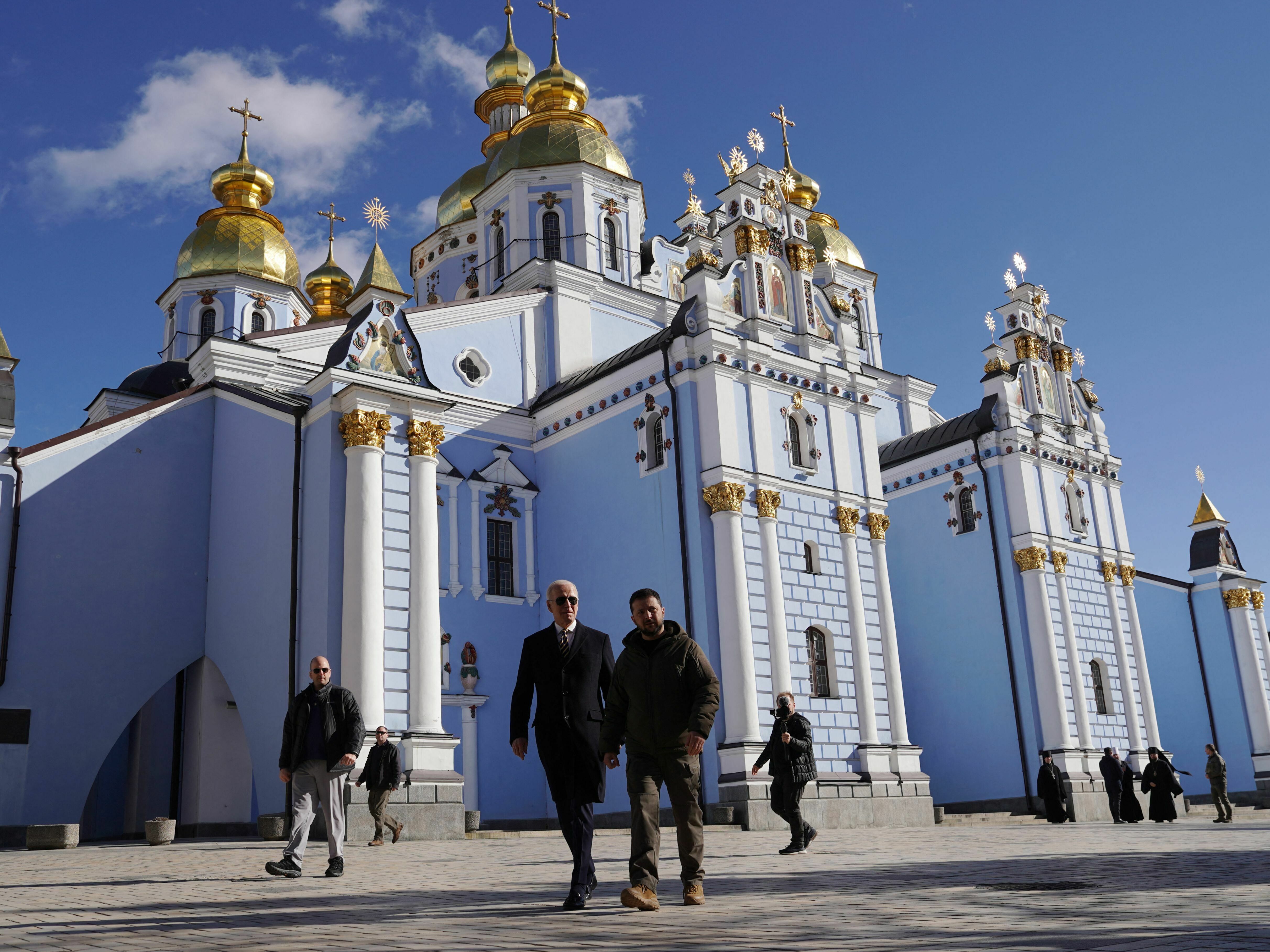 caption: President Biden and Ukrainian President Volodymyr Zelenskyy walk in front of St. Michael's cathedral in Kyiv ahead of the anniversary of Russia's invasion of Ukraine.