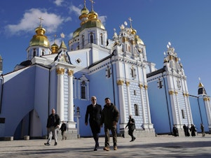 caption: President Biden and Ukrainian President Volodymyr Zelenskyy walk in front of St. Michael's cathedral in Kyiv ahead of the anniversary of Russia's invasion of Ukraine.