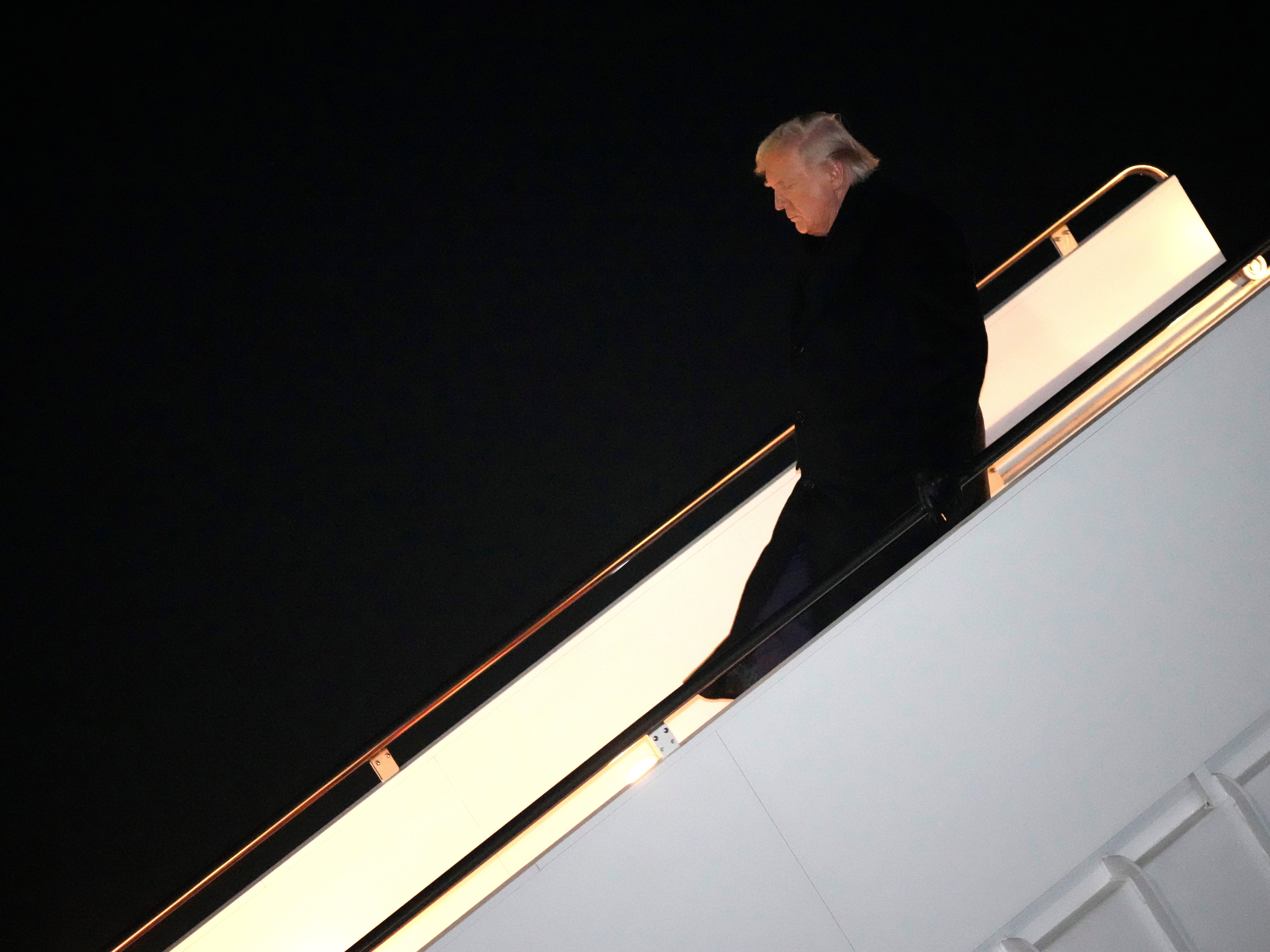 caption: President Donald Trump steps off Air Force One, early Monday, Feb. 9, 2026, at Joint Base Andrews, Md., after returning from a trip to Florida.