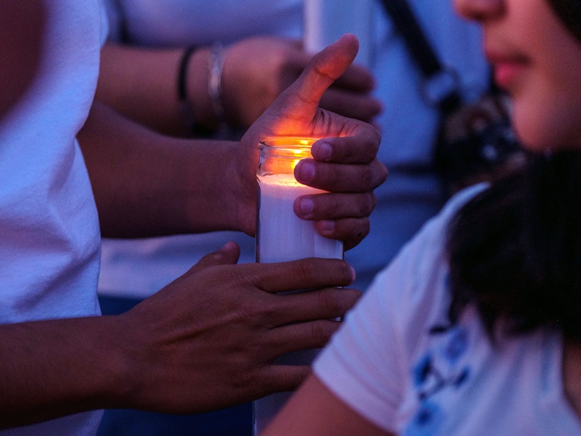 caption: Mourners hold candles as they gather for a vigil at a memorial outside Cielo Vista Walmart in El Paso, Texas, U.S., on Wednesday, Aug. 7, 2019.