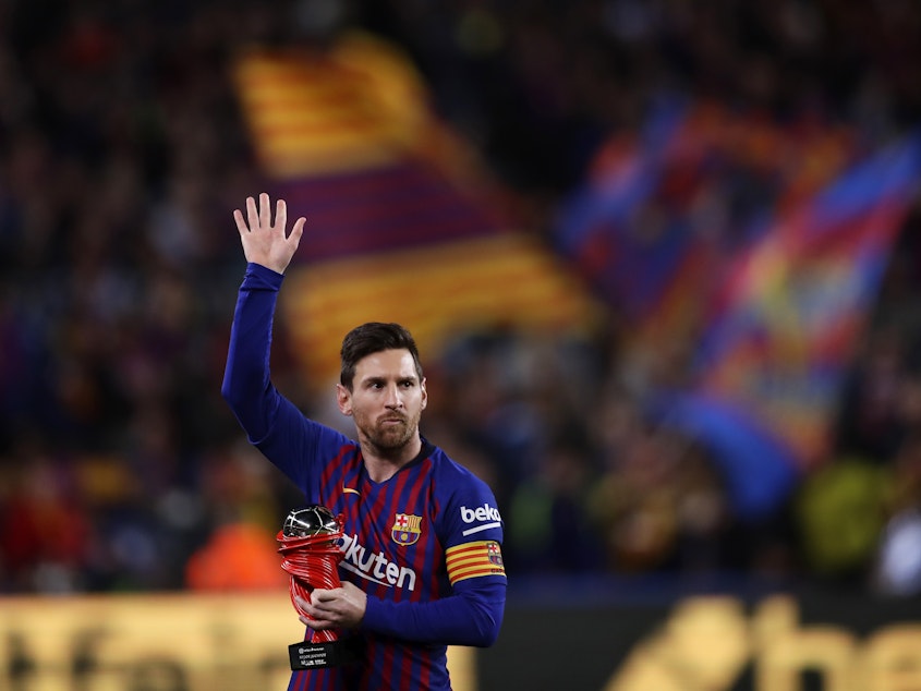 caption: In this 2019 file photo, Lionel Messi waves at the crowd as he holds the trophy of the best Spanish La Liga player prior to a soccer match between FC Barcelona and Atletico Madrid at the Camp Nou stadium in Barcelona, Spain. Barcelona says Lionel Messi will not stay with the club.
