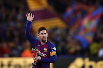 caption: In this 2019 file photo, Lionel Messi waves at the crowd as he holds the trophy of the best Spanish La Liga player prior to a soccer match between FC Barcelona and Atletico Madrid at the Camp Nou stadium in Barcelona, Spain. Barcelona says Lionel Messi will not stay with the club.