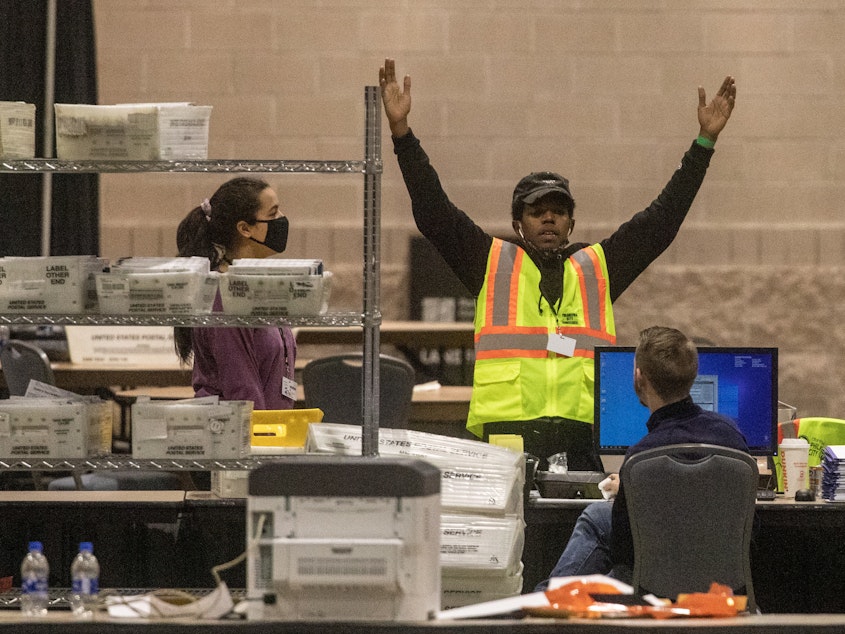 caption: An election worker talks with a colleague during ballot counting Nov. 6 in Philadelphia. Pennsylvania certified its election results on Tuesday.