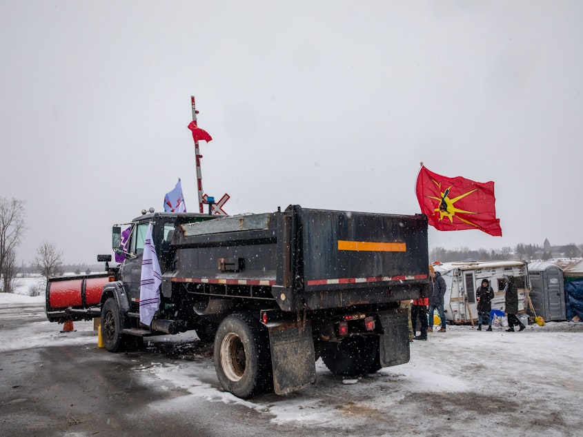 caption: A truck sits parked at railway tracks during a protest near Belleville, Ontario, Canada, on Thursday. Demonstrators have been disrupting railroads and other infrastructure across Canada for more than a week to protest TC Energy Corp.'s planned $4.68 billion (6.2 billion Canadian dollar) Coastal GasLink pipeline.
