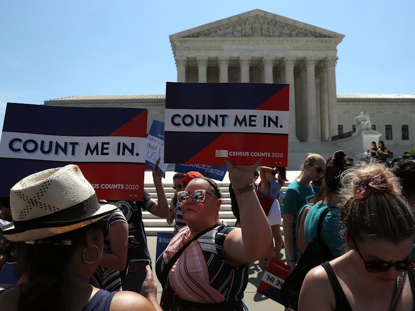 caption: People gather in front of the U.S. Supreme Court last month as decisions are handed down, including on the census.