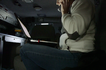 caption: Detective Wendy Willette of Washington's Department of Fish and Wildlife in the police van. Willette heads an operation to unravel a shellfish black market that has sprung up in South Puget Sound.