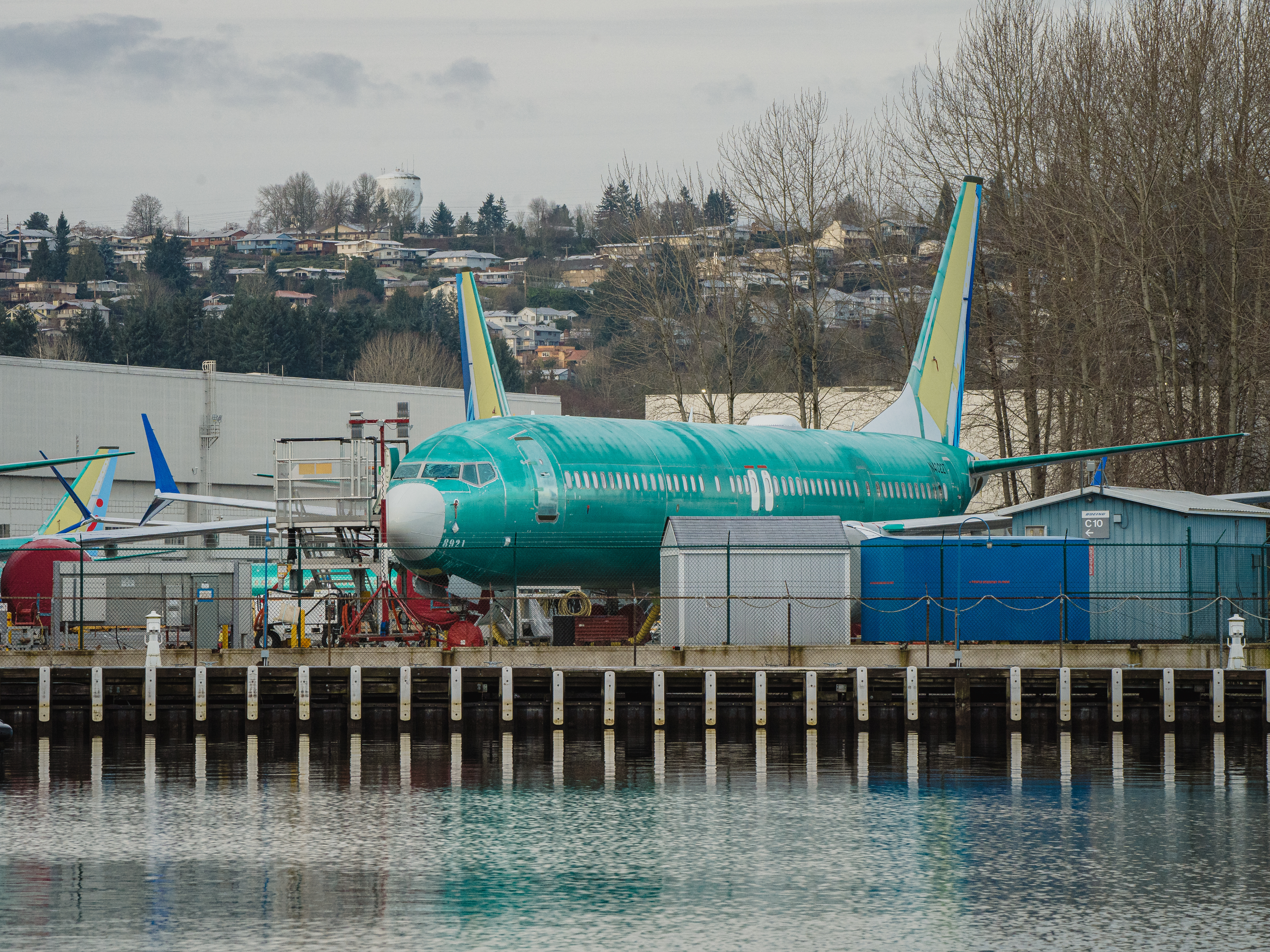 caption: Boeing is under heightened scrutiny from regulators and the public after a door plug panel blew off a jet in midair two months ago. Now the Justice Department is conducting a criminal investigation. Several Boeing 737 Max planes under construction in Renton, Wash. are shown outside the company's plant on February 27, 2024.
