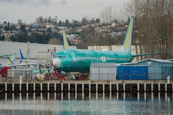 caption: Boeing is under heightened scrutiny from regulators and the public after a door plug panel blew off a jet in midair two months ago. Now the Justice Department is conducting a criminal investigation. Several Boeing 737 Max planes under construction in Renton, Wash. are shown outside the company's plant on February 27, 2024.