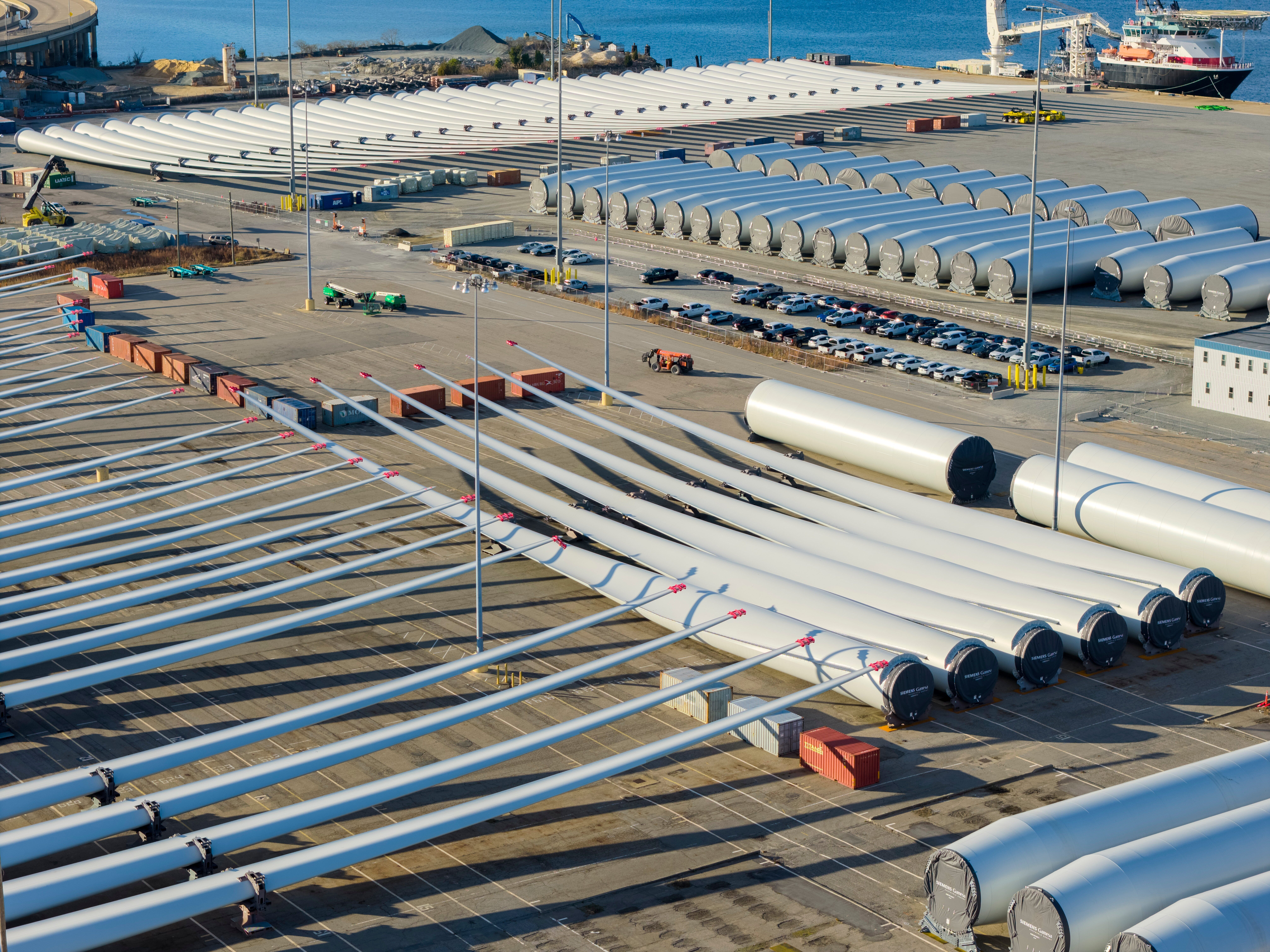 caption: Wind turbine bases, generators and blades sit at The Portsmouth Marine terminal that is the staging area for Dominion Energy Virginia, which is developing Coastal Virginia Offshore Wind, on Dec. 22 in Portsmouth, Va.