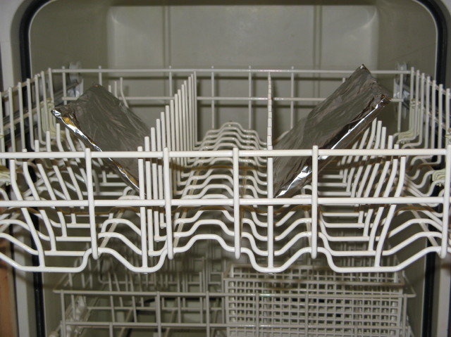 caption: An adventurous chef attempts to cook salmon in his dishwasher. 