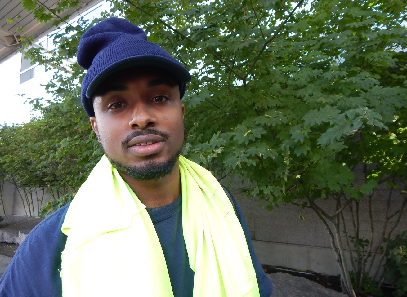 caption: Liban Ahmed handles baggage at Seattle-Tacoma International Airport. He says he'll use the extra money to buy a car, save for college and visit his mom in Mogadishu. He has not seen her in 15 years.