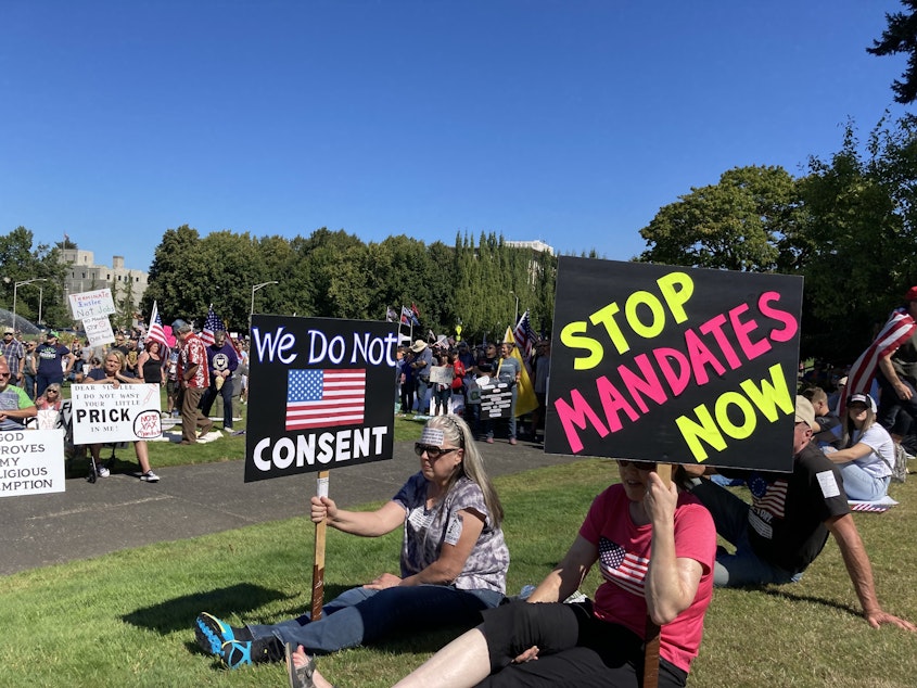 caption: People opposed to vax mandates protested at the Washington State Capitol in Olympia on multiple weekends during September.