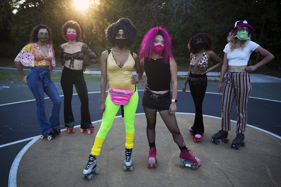 caption: Co-founders of Seattle Skates, Artemis Peacocke, center left, and Naima Pai, center right, pose for a portrait with roller skaters from left, Jenna O'Neil, Vanessa Poston, Nadia Morris and Erika Mazza-Smith, during a decades themed skate meet up on Tuesday, October 6, 2020, at the White Center Bicycle Playground in Seattle. 
