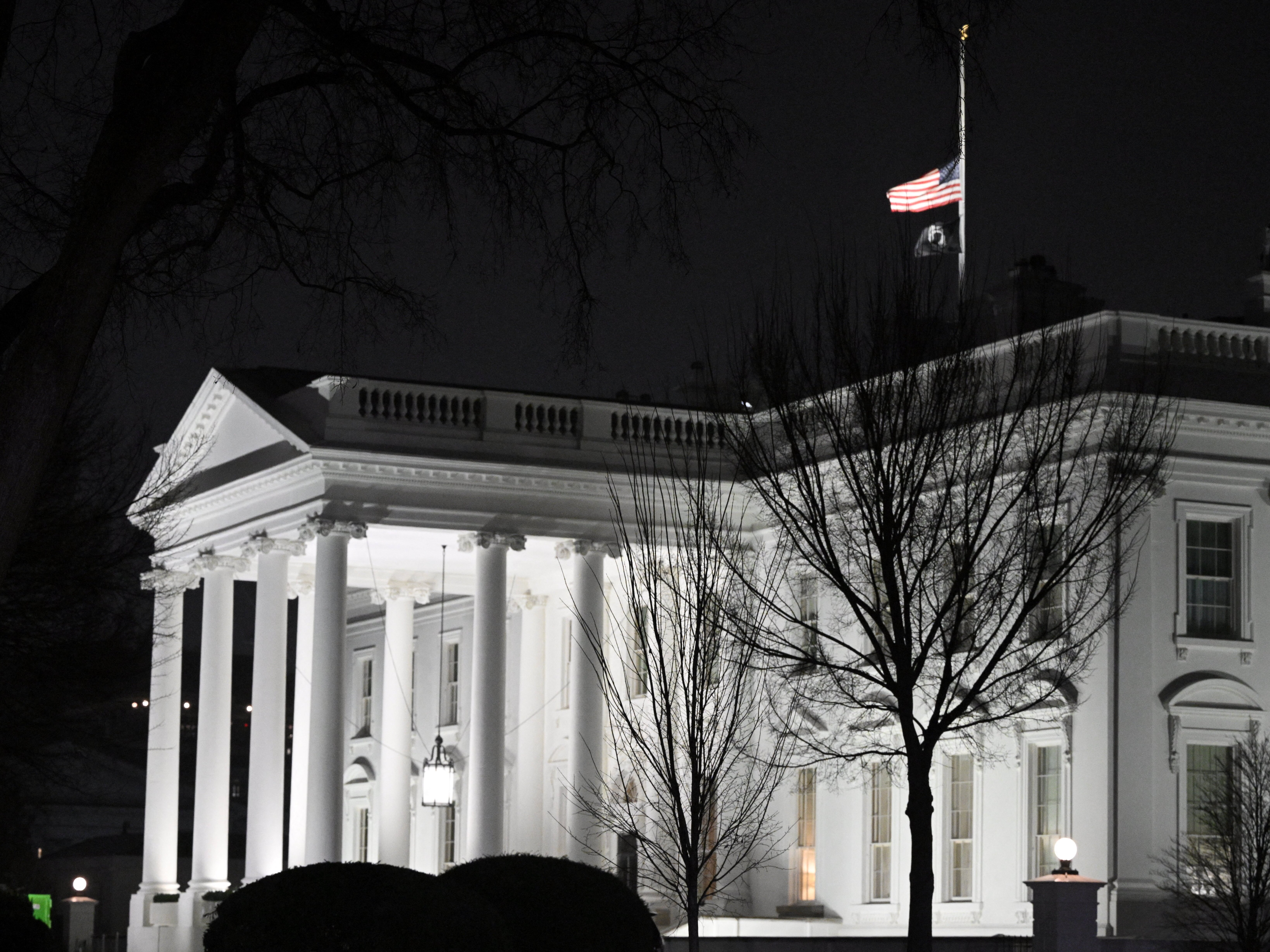 caption: On Friday, President Biden will award the United States' highest military decoration, the Medal of Honor, to service members who displayed exceptional valor in combat. Here, the U.S. flag flies at half-staff above the White House following the death of former President Jimmy Carter on Dec. 29.