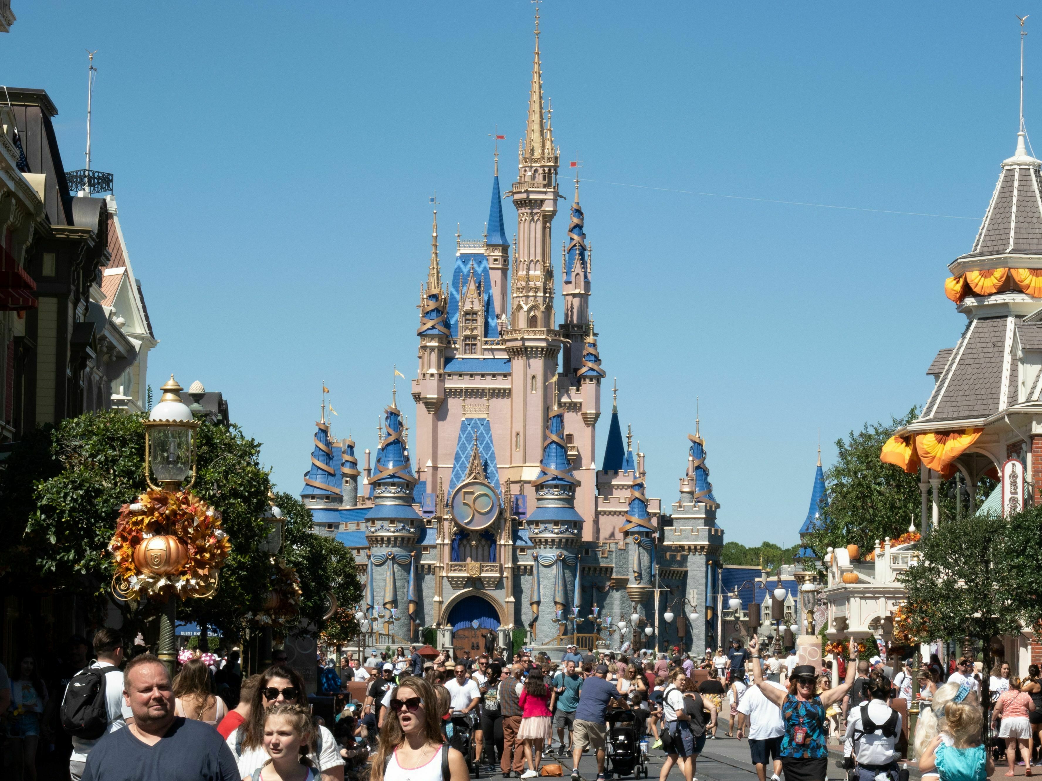 caption: Visitors walk along Main Street at Walt Disney World's Magic Kingdom in September 2022. Last week, Florida Gov. Ron DeSantis signed a bill to move Disney World's special tax district under quasi-government control.