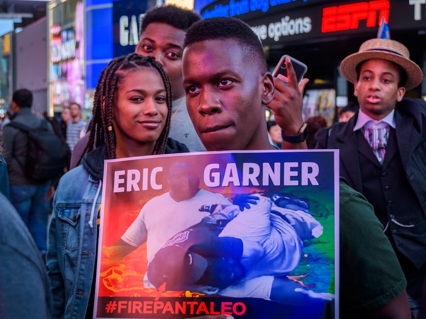 caption: Members of Black Lives Matter of Greater New York and allies hold a protest rally last month in New York City's Times Square demanding justice for Eric Garner, who died after he was put in a chokehold by an NYPD officer in 2014.