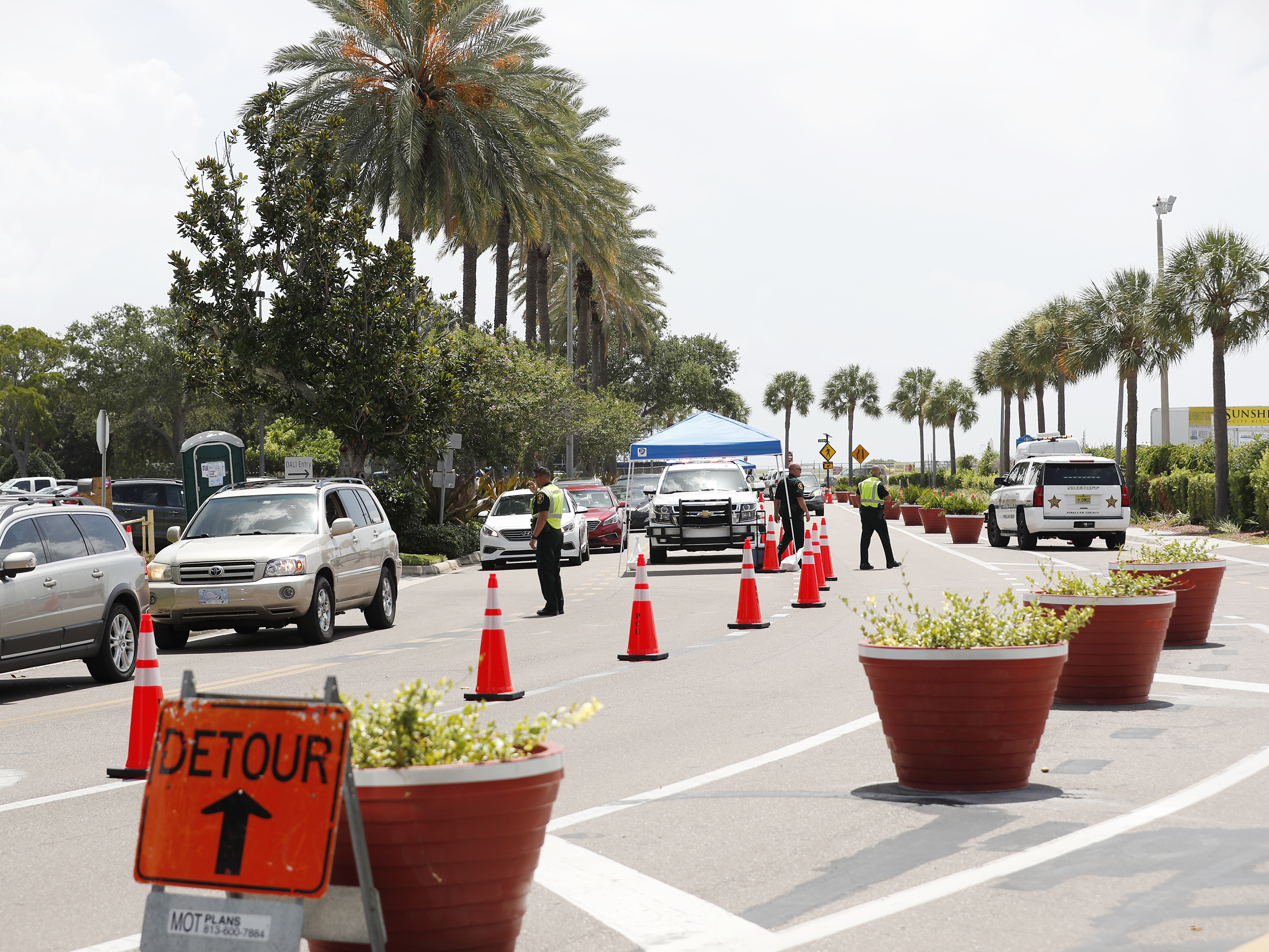 caption: Cars line up for drive-through coronavirus testing in St. Petersburg, Florida. The state reported a record-breaking 15,299 new cases on Sunday.