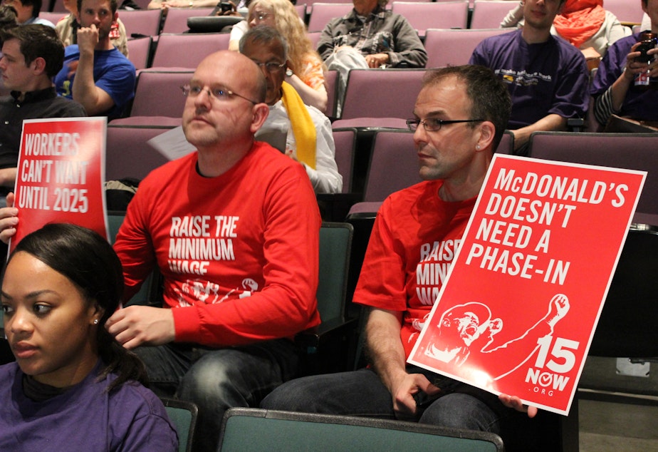 caption: Organizers for 15 Now, a campaign to change the city charter to include a $15 hourly wage. 