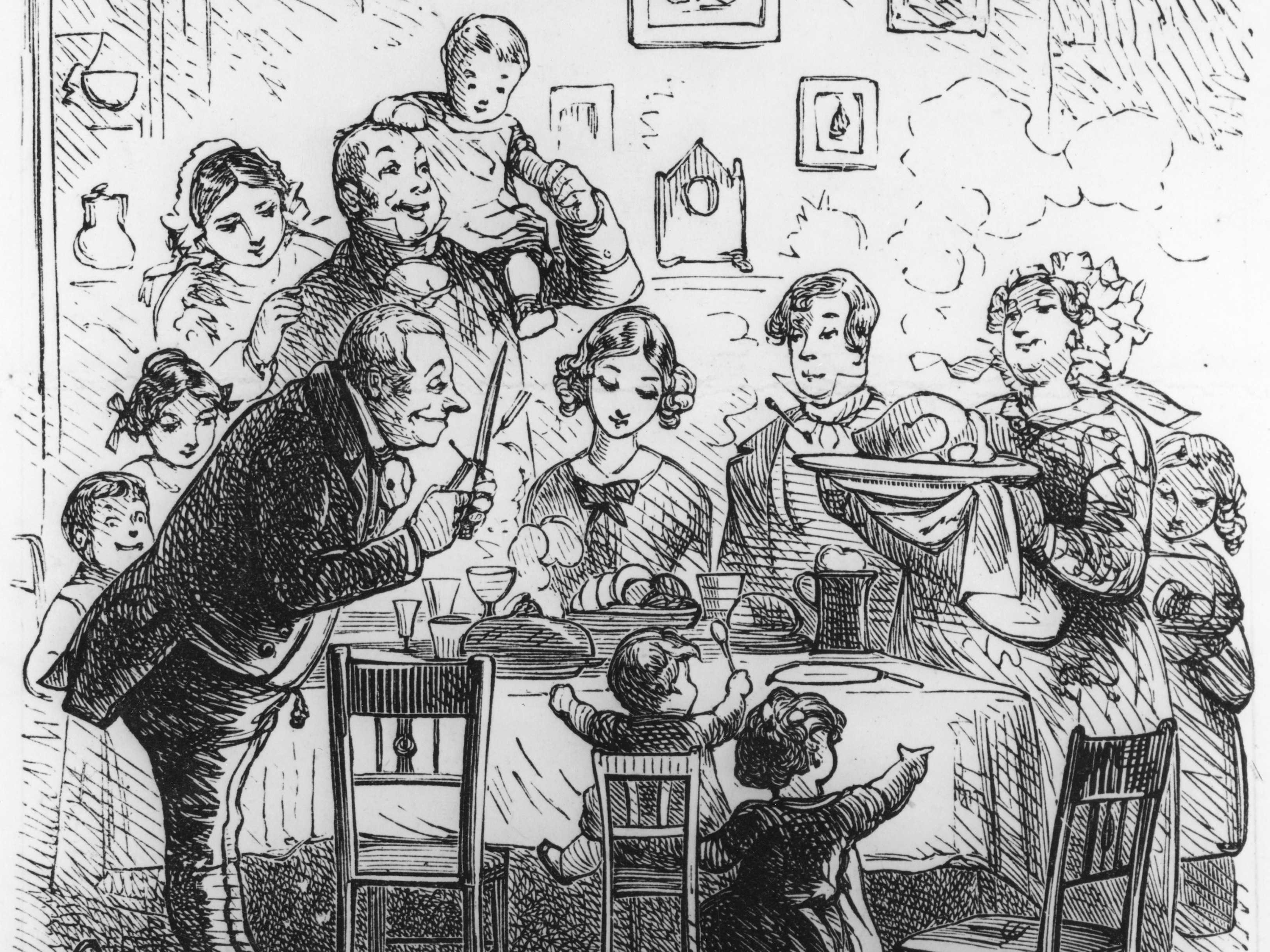 caption: A family at their Victorian-era Christmas dinner, circa 1840.