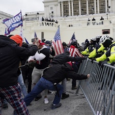 caption: Trump supporters try to break through a police barrier Jan. 6 at the U.S. Capitol in Washington, D.C.
