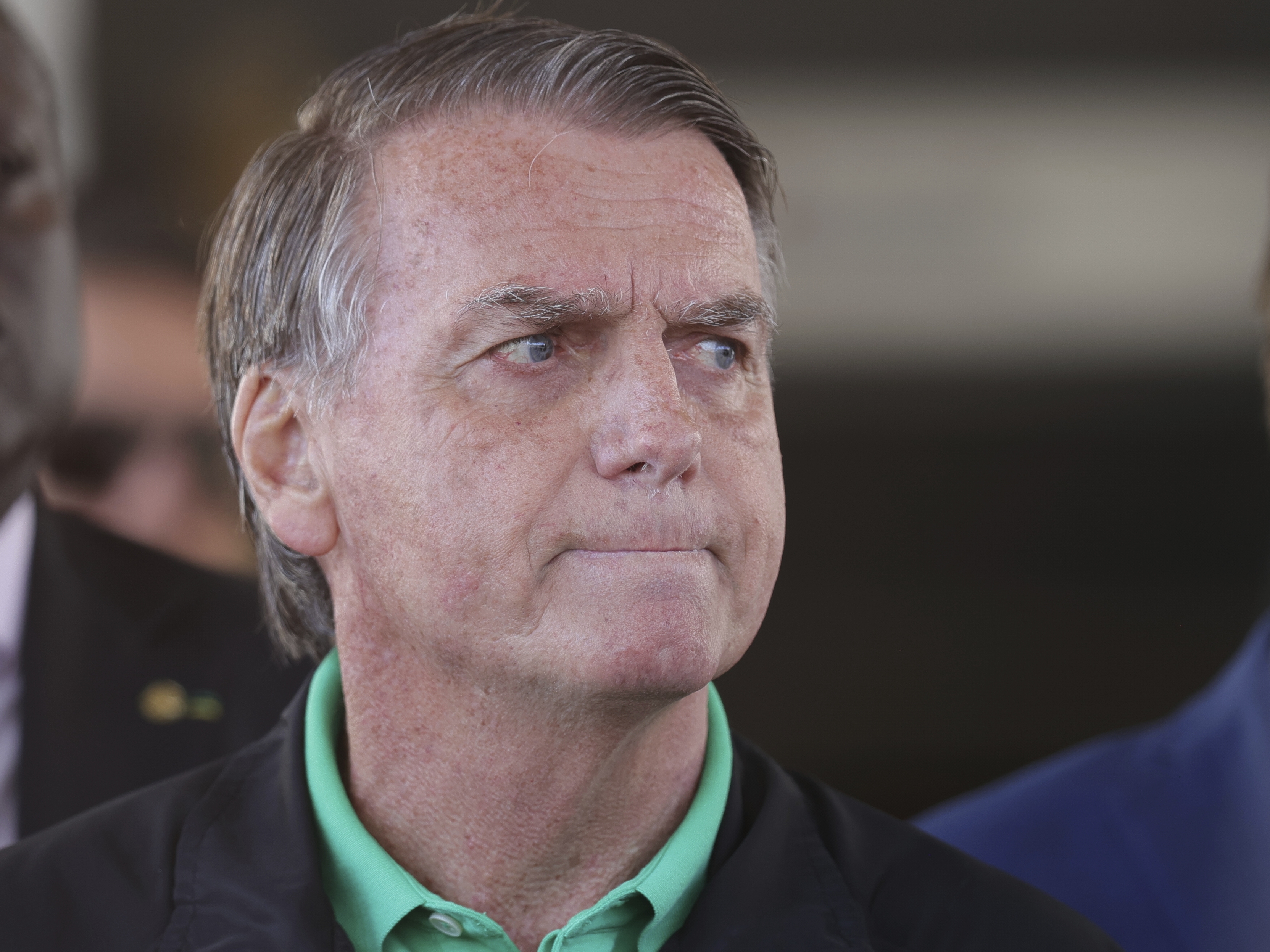 caption: Brazil's former President Jair Bolsonaro gives a press conference outside the Senate in Brasilia.