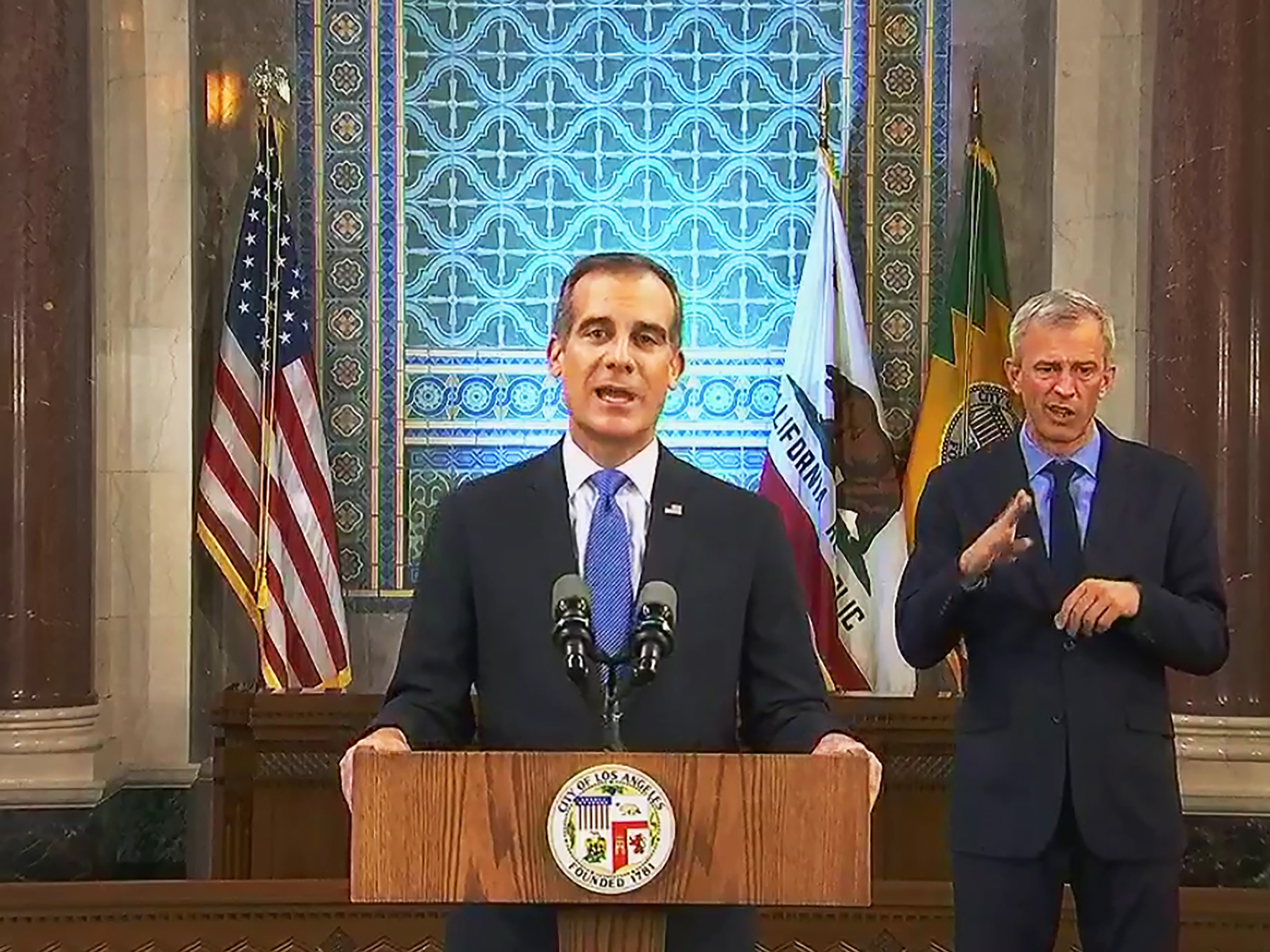 caption: Los Angeles Mayor Eric Garcetti, pictured giving his annual State of the City speech in  April, announced on Wednesday that he is authorizing the Department of Water and Power to shut off service at properties hosting large parties, which are forbidden under coronavirus health orders.