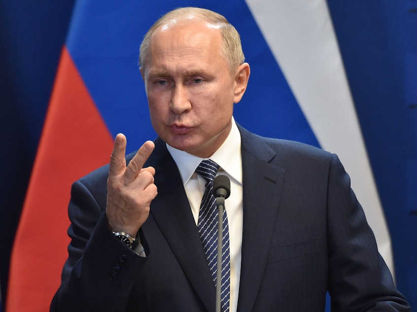 caption: Russian President Vladimir Putin has signed a law giving the government the right to register individual journalists and bloggers as foreign agents. Putin is seen here in Budapest in October.