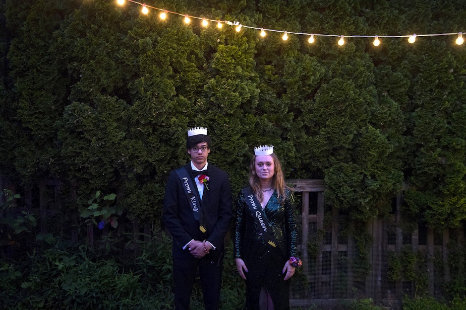 caption: Leo Padua, left, a senior at Ingraham High School, and Morgen White, right, a senior at Ballard High School, stand for a portrait during their own personal prom celebration in Leo's backyard on Saturday, May 23, 2020, in Seattle. 