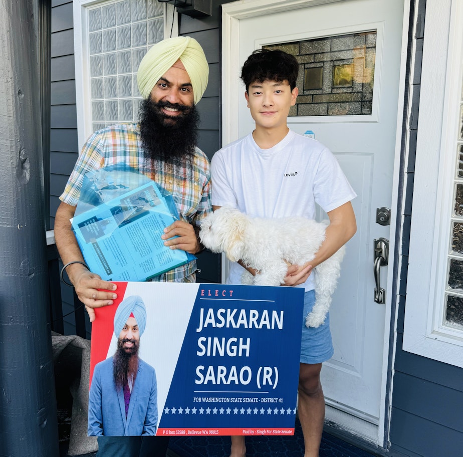 caption: Jaskaran Singh Sarao, left, during a door-knocking effort.